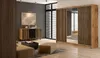 A modern bedroom or living room with a large wardrobe, a sideboard, and a coffee table. Produktbild-Vorschau