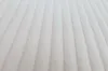 A close-up view of a textured, cream-colored fabric with vertical ribbed lines. Anteprima dell’immagine prodotto