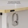 Close-up of a desk with headphones hanging from a hook, illustrating a feature. Podgląd zdjęcia produktu