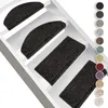 Several dark-colored stair mats are shown on white stairs. A color palette of different stair mat colors is displayed on the right side. Produktbild-Vorschau