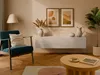 A living room scene featuring a teal armchair, a floating white TV lowboard with decorative items, and a coffee table. Produktbild-Vorschau