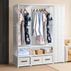 A white fabric wardrobe with clothes hanging on racks and storage bins below. Náhľad obrázku produktu