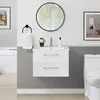 A modern bathroom vanity with a sink, faucet, and drawers, next to a toilet, with a mirror and artwork on the wall. Produktbild-Vorschau