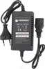 A black Powermat power adapter with two cables attached, one with a European plug and the other with a connector for a device. Produktbild-Vorschau
