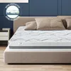 A mattress on a bed with pillows, in a bedroom setting. Produktbild-Vorschau