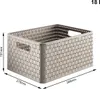 A beige woven storage basket with handles, shown from a diagonal front-left perspective. Dimensions are indicated with lines and text. Anteprima dell’immagine prodotto
