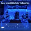 A house decorated with blue Christmas lights. Produktbild-Vorschau
