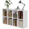 A white modular shelving unit filled with books, decorative boxes, and a storage bin. Podgląd zdjęcia produktu