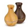 Two aroma diffusers with a wood grain finish are displayed against a white background. Produktbild-Vorschau