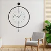 A modern living room with a decorative wall clock and a chair. Náhľad obrázku produktu