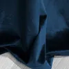 A close-up of draped navy blue velvet fabric. Podgląd zdjęcia produktu