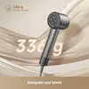 A hairdryer is shown against a backdrop of flowing fabric. Náhled obrázku produktu