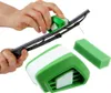 A person is using a green and white tool to clean a car windshield wiper blade. A green sponge and another part of the tool are also visible. Produktbild-Vorschau