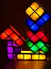 A stack of colorful, illuminated Tetris-like blocks arranged in a playful, abstract sculpture against a dark background. Produktbild-Vorschau