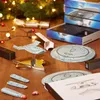 Star Trek model kits and accessories are displayed on a wooden surface with Christmas lights and a tree in the background. Podgląd zdjęcia produktu