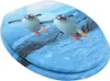 A toilet seat with a printed image of two penguins swimming in water. Náhled obrázku produktu
