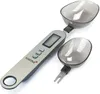 A digital spoon scale with two detachable scoops, shown on a white background. Voir les images du produit