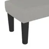 A close-up view of the bottom part of a light gray upholstered bench with black legs. Náhled obrázku produktu