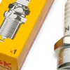 A close-up of a spark plug and its packaging. Produktbild-Vorschau