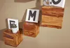 Three wooden cube shelves are mounted on a light brown wall, each displaying decorative items. Produktbild-Vorschau