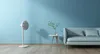 A minimalist living room scene with a fan and a sofa. Anteprima dell’immagine prodotto