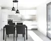 A modern kitchen and dining area with a pendant light fixture over a table. Náhled obrázku produktu