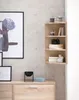 A corner shelf unit with decorative items and a framed picture on a textured wall. Anteprima dell’immagine prodotto