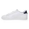 A side view of a white Puma sneaker with a navy heel accent. Produktbild-Vorschau