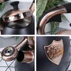 A collage of four close-up shots of a black kettle with copper accents. Náhled obrázku produktu