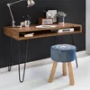 A wooden desk with metal hairpin legs and a denim stool in front of it, set against a black wall. Produktbild-Vorschau