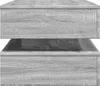 Close-up view of a grey wooden furniture item, possibly a table or shelf unit, showing its textured surface and layered structure. Anteprima dell’immagine prodotto