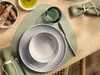 A table setting with plates, cutlery, a glass, and bread. Produktbild-Vorschau
