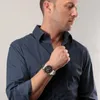 A man wearing a blue shirt and a watch. Náhľad obrázku produktu
