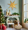 A festive Christmas scene with a decorated tree, gifts, and decorative items on a console table. Náhled obrázku produktu