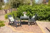 A garden furniture set with chairs and a table on a patio. Produktbild-Vorschau