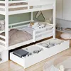 A white bunk bed with storage drawers underneath, filled with toys and bedding. Náhled obrázku produktu