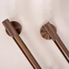 Close-up view of two metallic bathroom hooks mounted on a white wall. Anteprima dell’immagine prodotto