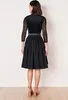 A woman is shown from the back wearing a black dirndl dress. Produktbild-Vorschau