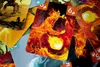 A close-up view of several cards from a card game, with a prominent card featuring a fiery elemental creature in the center. Produktbild-Vorschau