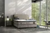 A bedroom scene with a bed, nightstand, and a large window overlooking a garden. Produktbild-Vorschau