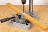 A drill press is shown drilling a hole in a wooden plank held by a vise. Náhľad obrázku produktu