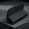 A black leather iPhone case with red stitching is shown in a studio setting, propped up to display its stand function. Produktbild-Vorschau