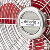 Close-up of a red and silver fan with a logo. Produktbild-Vorschau