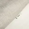A close-up of a fabric texture with a small brand tag. Produktbild-Vorschau