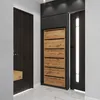 A modern entryway with a dark wood door, a black and wood shoe cabinet, and a black door with a vertical light strip. Produktbild-Vorschau