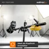 A studio lighting stand with a light attached and a counterweight, set up in a studio environment with softboxes in the background. Voir les images du produit