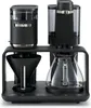 A black coffee machine with a grinder and carafe is shown against a white background. Produktbild-Vorschau