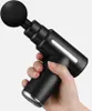 A hand holding a black massage gun against a white background. Produktbild-Vorschau