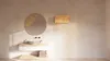 A minimalist bathroom vanity with a sink, mirror, and a floating shelf. Produktbild-Vorschau