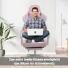 A man is sitting in a pink gaming chair with a laptop on his lap, demonstrating the chair's comfort and versatility. Náhled obrázku produktu